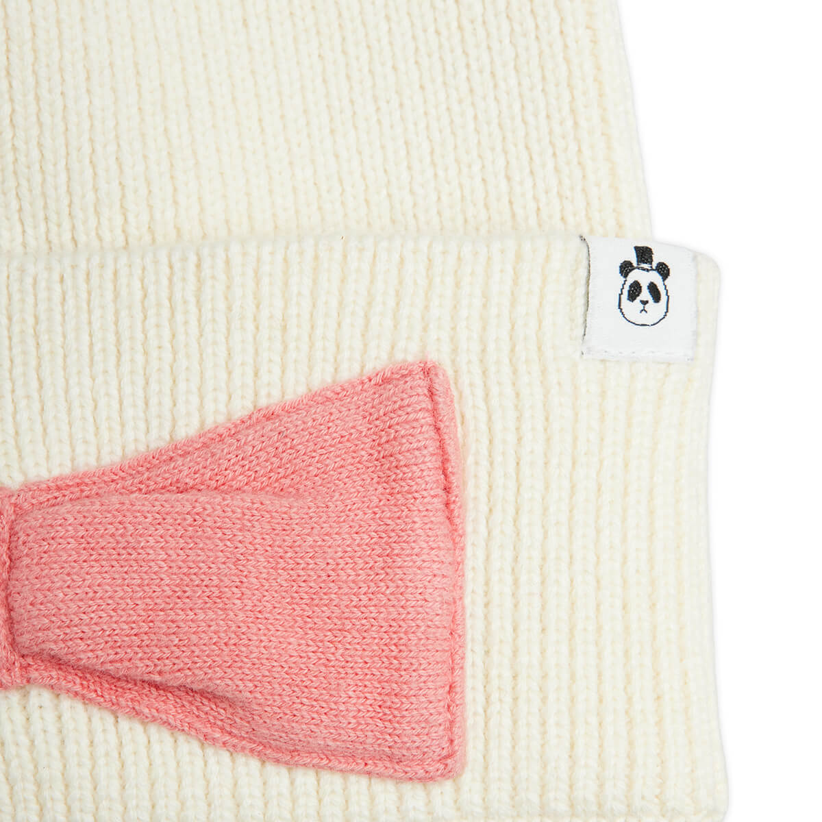 Bonnet d'hiver pour enfants, orné d'un nœud blanc cassé, en coton et laine bio tricotés.